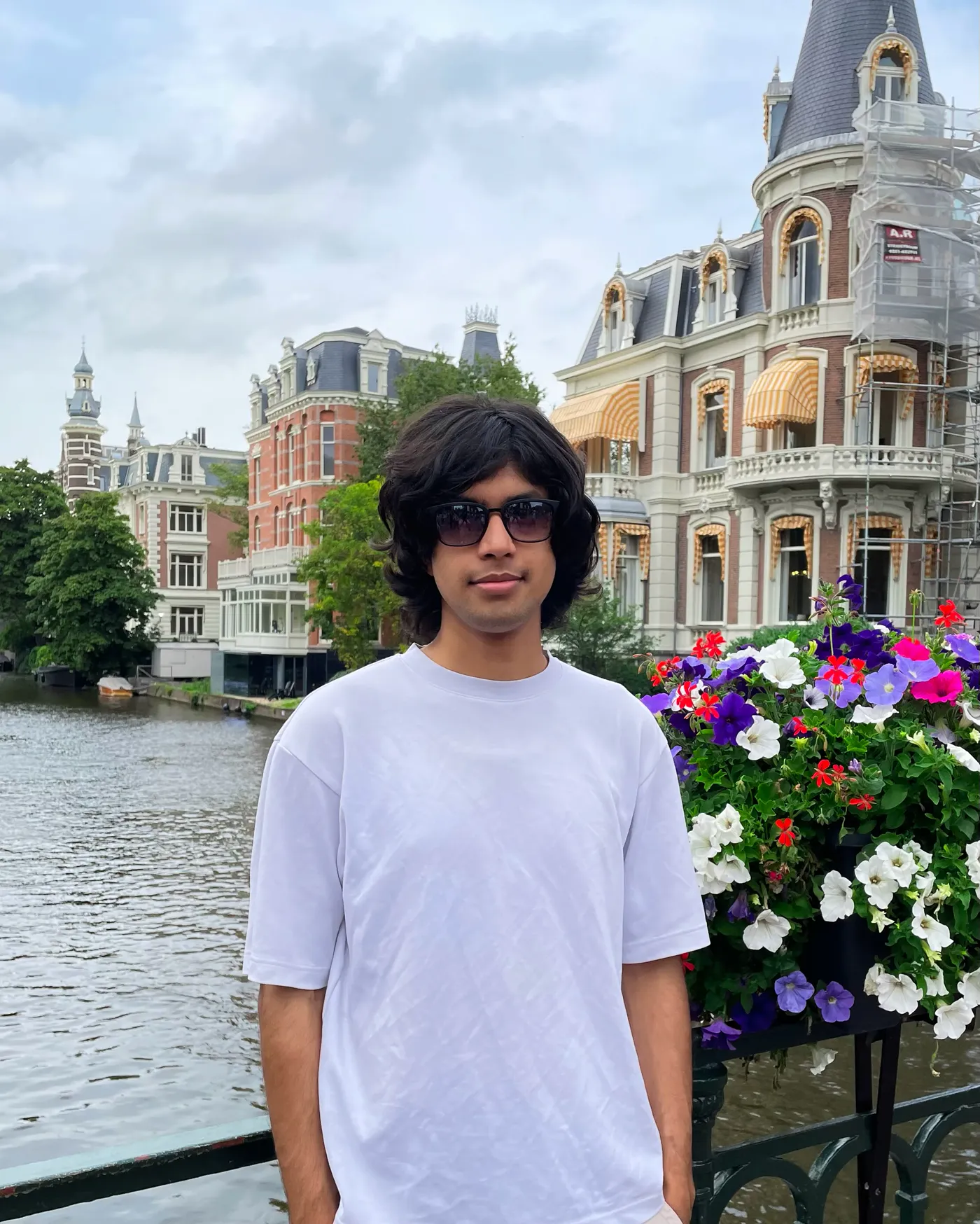 Saksham on a canal bridge in Amsterdam